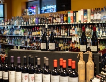 Rows of premium wine bottles highlighting a diverse global wine selection and pairings.