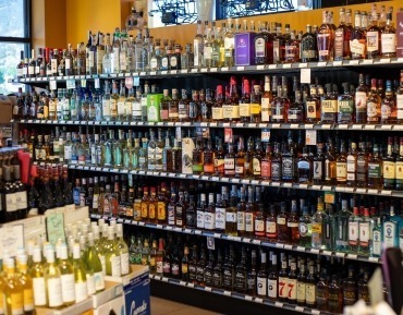 Premium bottles of specialty liqueurs and cocktail bitters on a shelf at a liquor store in Durango.